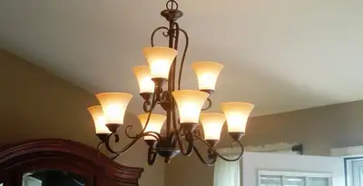 Classic ceiling chandelier installation with warm lighting in Seattle, WA