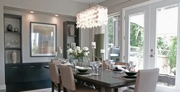 Elegant dining room chandelier installation above table in Seattle, WA