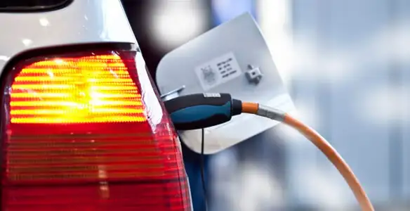 Electric car plugged into EV charger after professional installation in Seattle, WA