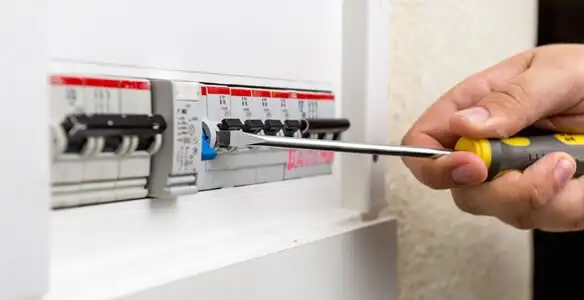 electrical panel upgrade service showing technician adjusting circuit breakers during system upgrade in Seattle, WA