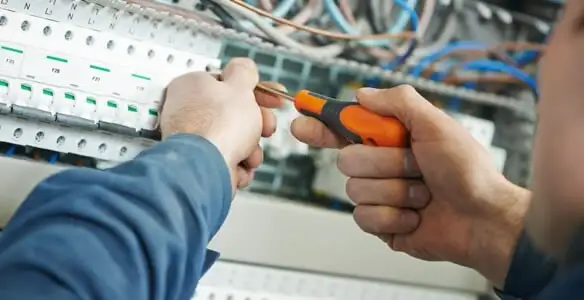 electrical service showing licensed electrician performing electrical panel maintenance and adjustments in Seattle, WA