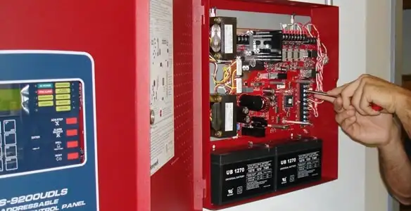 fire alarm installation service showing technician configuring fire alarm control panel in Seattle, WA