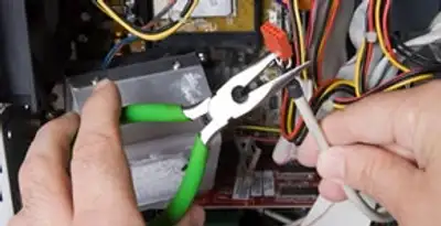 Licensed electrical contractor performing electrical repair with tools in Bothell, WA