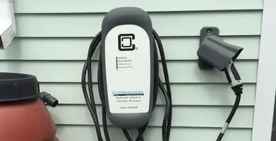 Outdoor electric vehicle charger installation on residential wall in Seattle, WA