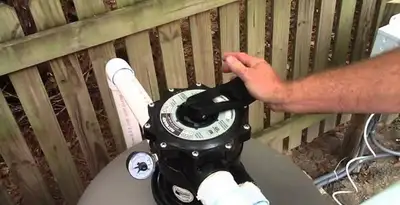 pool pumps service showing professional adjustment of pool pump control system in Seattle, WA