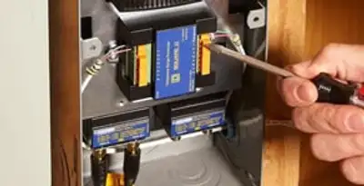 Whole home surge protection device being installed by a licensed electrician to protect electrical systems in Seattle, WA